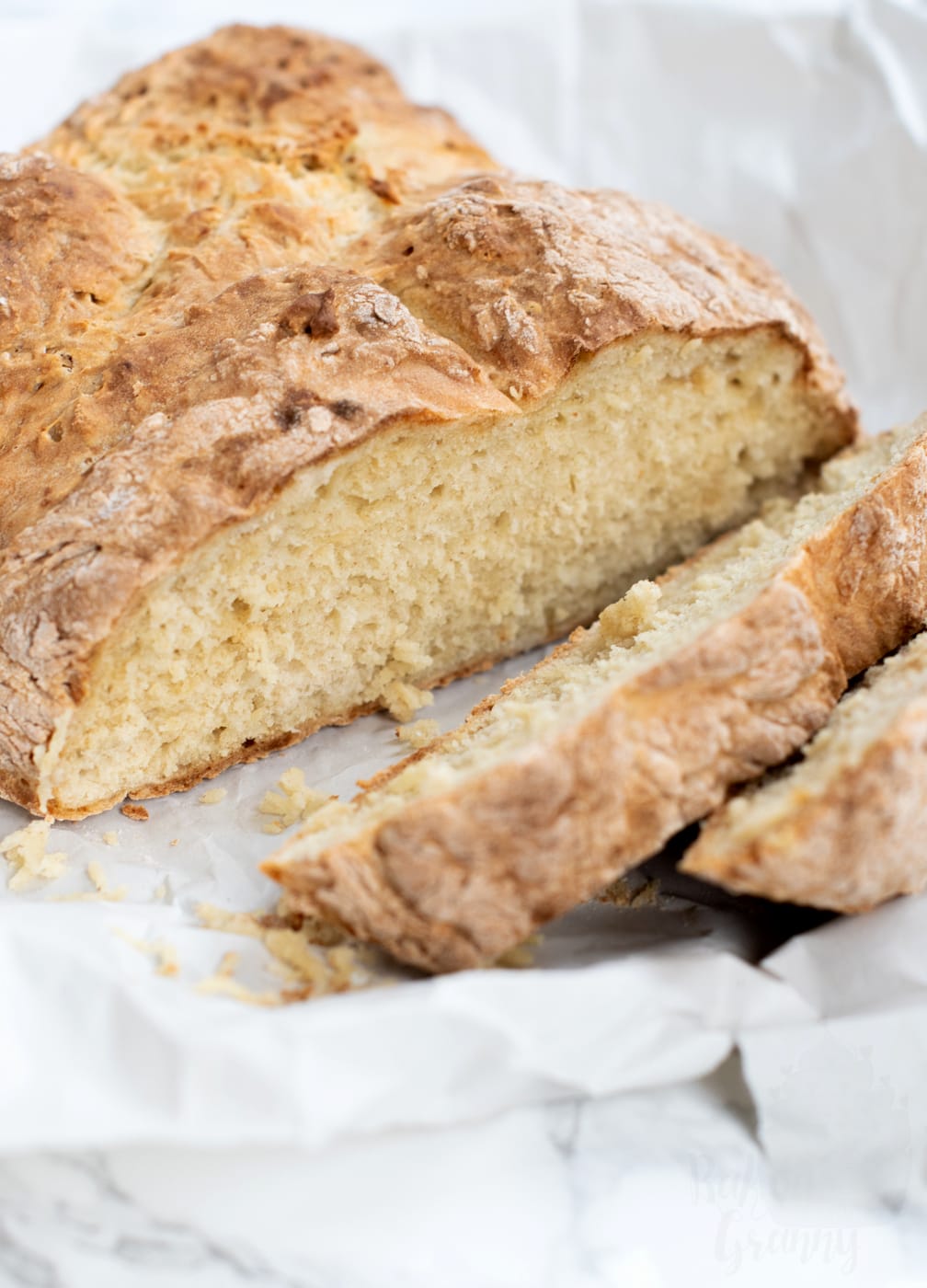 Close-up of sliced traditional Irish soda bread showing the tender crumb from this easy no-yeast bread recipe.