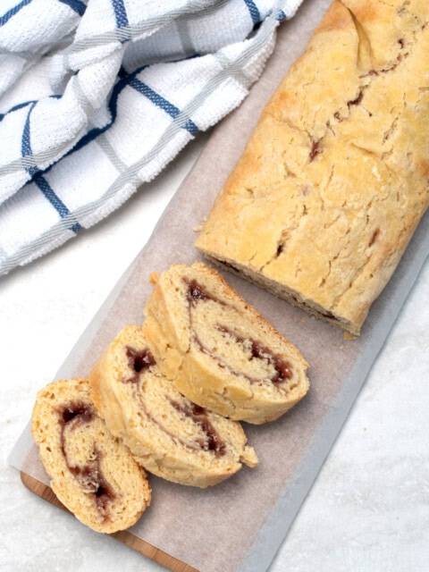 Jam Roly Poly recipe from Baking with Granny. Delicious golden roll, made with traditional suet dough. Filled with raspberry jam. Served in slices.