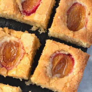 Plum cake with baked plum halves set into golden sponge.