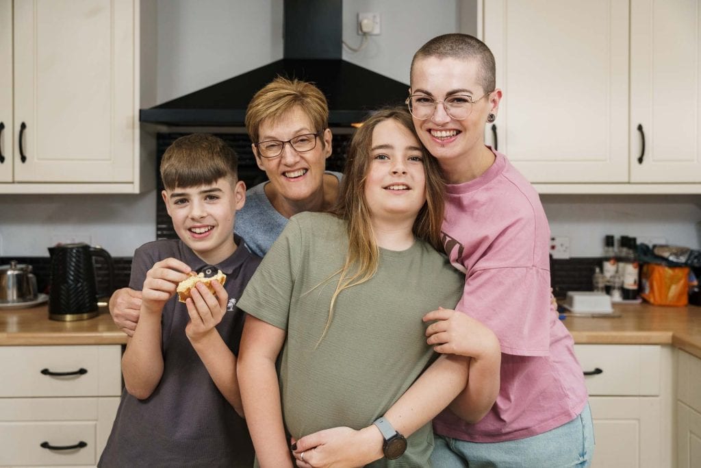 Amy Beth Reid, with her mother and two sons, in her mother's kitchen.