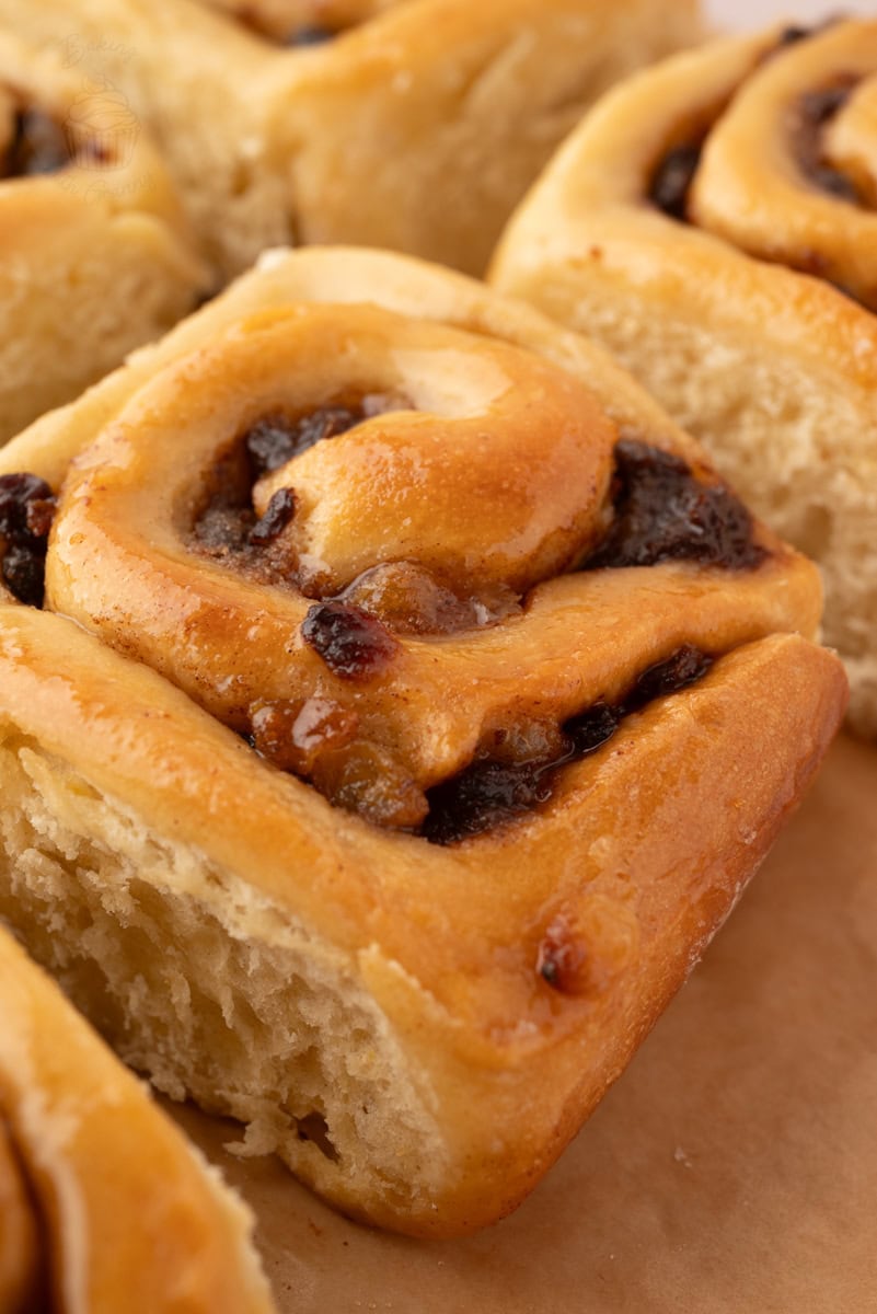 Close-up of a sticky glazed Chelsea Bun with currants and sultanas in the spiced filling.