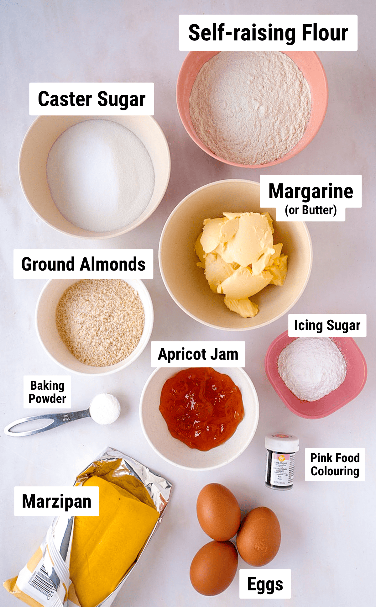 Ingredients for Battenberg Cake including flour, sugar, margarine, ground almonds, eggs, jam and marzipan.