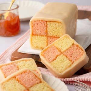 Battenberg cake with pink and plain checkerboard sponge wrapped in marzipan.