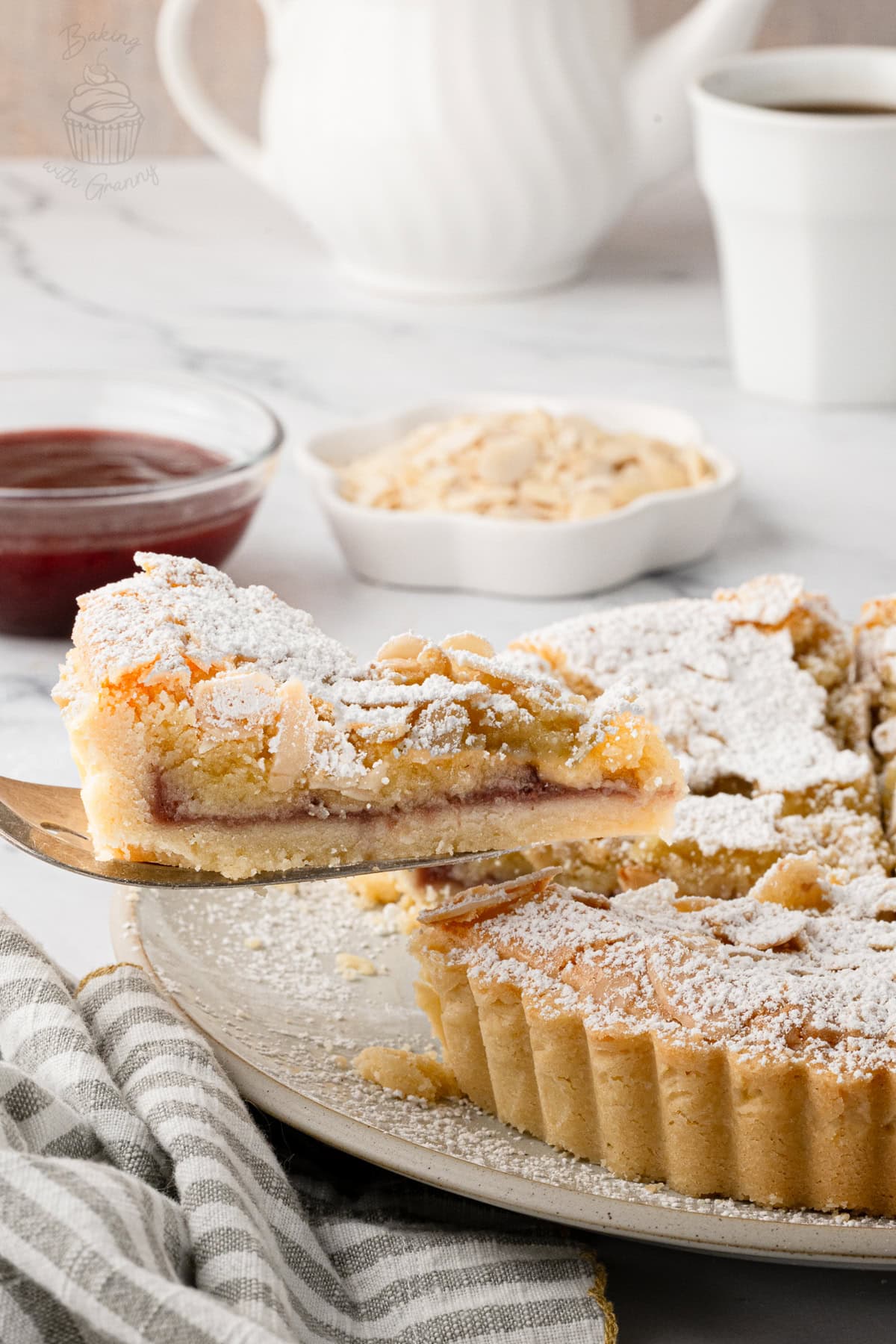 Slice of Bakewell Tart showing the raspberry jam and soft almond frangipane.